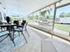 Bright and airy screened porch with tile flooring, offering a comfortable transition to the outdoor pool area at 6398 17Th N Pl, St Petersburg, FL 33710