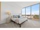This bedroom features a large window with city views, a bed, bedside tables, and a modern design at 777 3Rd N Ave # 805, St Petersburg, FL 33701