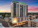 Exterior dusk view of the Reflection Residences, a luxurious high-rise with a green lit-up top at 777 3Rd N Ave # 805, St Petersburg, FL 33701