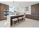 Modern kitchen featuring a center island with seating, wood and white cabinetry, and stainless steel appliances at 777 3Rd N Ave # 805, St Petersburg, FL 33701