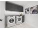 Clean laundry room with side-by-side washer and dryer and overhead cabinets at 777 3Rd N Ave # 805, St Petersburg, FL 33701