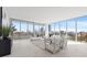 Bright, modern living room with floor-to-ceiling windows and contemporary white furniture at 777 3Rd N Ave # 805, St Petersburg, FL 33701