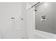 Shower with gray tiled accent wall, white shower curtain, and matte black shower fixtures at 777 3Rd N Ave # 805, St Petersburg, FL 33701