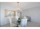 Dining area with glass table and chandelier, overlooking the kitchen and a picturesque waterfront view at 7922 Sailboat Key S Blvd # 503, South Pasadena, FL 33707