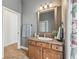 Bathroom features a wood vanity with a sink, a decorative mirror, and a neutral wall color at 8516 Lagerfeld Dr, Land O Lakes, FL 34637