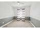 Cozy bedroom with neutral carpeting, ceiling fan, and a bright window at 8516 Lagerfeld Dr, Land O Lakes, FL 34637