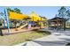 Community playground featuring a yellow shade canopy, slides, and a gazebo at 8516 Lagerfeld Dr, Land O Lakes, FL 34637