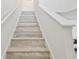 Staircase with wood-look treads and white risers leads to an upper level of the home at 8516 Lagerfeld Dr, Land O Lakes, FL 34637