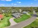 A high angle aerial view showcasing the property’s lush surroundings and circular brick driveway at 9665 Southern Belle Dr, Weeki Wachee, FL 34613