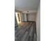 A spacious bedroom features modern gray flooring and a large walk-in closet for ample storage at 10033 64Th N Ave # 9, St Petersburg, FL 33708