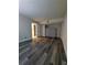 An ample bedroom features modern gray flooring, closet, and entry into adjacent room at 10033 64Th N Ave # 9, St Petersburg, FL 33708