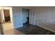 Cozy bedroom featuring wood-look flooring, a closet, and an adjacent doorway at 10033 64Th N Ave # 9, St Petersburg, FL 33708
