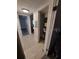Hallway with neutral paint, tile flooring, leading to rooms and storage area at 10033 64Th N Ave # 9, St Petersburg, FL 33708