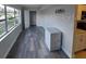 Living room featuring wood-look flooring, large windows, and neutral walls at 10033 64Th N Ave # 9, St Petersburg, FL 33708