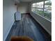 Bright living room showcasing wood-look floors and expansive window views at 10033 64Th N Ave # 9, St Petersburg, FL 33708