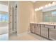 Bright bathroom showcasing double vanity and walk-in shower, blending style and practicality at 10432 Torchwood Sea Way, San Antonio, FL 33576