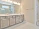 Elegant bathroom features a large vanity with double sinks, providing ample space and storage at 10432 Torchwood Sea Way, San Antonio, FL 33576