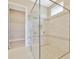 Luxurious walk-in shower with beautiful tiling and dual shower heads, creating a spa-like experience at 10432 Torchwood Sea Way, San Antonio, FL 33576