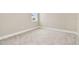 Bright bedroom with neutral carpet and a view of the neighborhood at 10432 Torchwood Sea Way, San Antonio, FL 33576