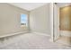 Serene bedroom with neutral carpet, natural light, and en-suite bathroom at 10432 Torchwood Sea Way, San Antonio, FL 33576