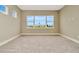 Well-lit bedroom with a large window offering scenic neighborhood views, providing a serene atmosphere at 10432 Torchwood Sea Way, San Antonio, FL 33576