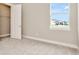 Cozy bedroom with closet and sunlit window showing neighborhood view at 10432 Torchwood Sea Way, San Antonio, FL 33576