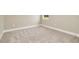 Bright, neutral bedroom featuring plush carpet and a window, complete with a painted baseboard at 10432 Torchwood Sea Way, San Antonio, FL 33576