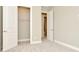 Comfortable bedroom featuring plush carpet, a closet, and an adjacent doorway with neutral paint at 10432 Torchwood Sea Way, San Antonio, FL 33576