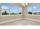Bright dining room featuring large windows overlooking a scenic view and chandelier at 10432 Torchwood Sea Way, San Antonio, FL 33576