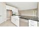 Modern kitchen featuring a center island, white cabinets, stainless steel appliances, and farmhouse sink at 10432 Torchwood Sea Way, San Antonio, FL 33576
