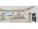 Modern kitchen with white cabinets, black countertops, stainless steel appliances, and stylish backsplash at 10432 Torchwood Sea Way, San Antonio, FL 33576