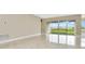 Large living room with marble floors, sliding glass doors, and backyard views at 10432 Torchwood Sea Way, San Antonio, FL 33576