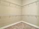 Organized walk-in closet with ample shelving, offering efficient storage for clothing and accessories at 10432 Torchwood Sea Way, San Antonio, FL 33576