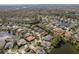 A scenic view of a community featuring mature trees, single-Gathering homes, and ponds at 10537 Greensprings Dr, Tampa, FL 33626