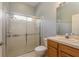 Bathroom featuring a glass door shower and a vanity with a single sink at 10537 Greensprings Dr, Tampa, FL 33626