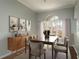 Well-lit dining room with a large window and view, complemented by modern furnishings and decor at 10537 Greensprings Dr, Tampa, FL 33626
