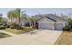 Beautiful single-Gathering home with a well-manicured lawn and three car garage at 10537 Greensprings Dr, Tampa, FL 33626