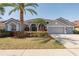 Charming home with a three-car garage, well-manicured lawn, and tropical landscaping at 10537 Greensprings Dr, Tampa, FL 33626