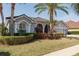 Beautifully landscaped home featuring lush greenery and a well-maintained lawn at 10537 Greensprings Dr, Tampa, FL 33626
