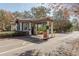 Community's gatehouse features manicured landscaping and security features at 10537 Greensprings Dr, Tampa, FL 33626