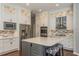 Gourmet kitchen showcasing custom cabinetry, stainless steel appliances, and a center island with bar stools at 10537 Greensprings Dr, Tampa, FL 33626