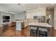 Open-concept kitchen featuring a large island with seating, stainless steel appliances, and modern fixtures at 10537 Greensprings Dr, Tampa, FL 33626