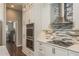 Elegant kitchen with stainless steel appliances, modern cabinets, subway tile backsplash, and a range hood at 10537 Greensprings Dr, Tampa, FL 33626