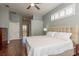 Spacious main bedroom with hardwood floors, neutral tones, and an ensuite bathroom at 10537 Greensprings Dr, Tampa, FL 33626