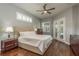 Serene main bedroom with hardwood floors, neutral tones, and French doors leading to the outdoor area at 10537 Greensprings Dr, Tampa, FL 33626