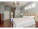 Light and bright main bedroom with wood floors, neutral paint, and an ensuite bathroom at 10537 Greensprings Dr, Tampa, FL 33626