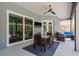 Covered patio featuring comfortable seating, an outdoor TV, and access to the pool at 10537 Greensprings Dr, Tampa, FL 33626