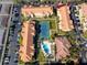 Aerial view of a community featuring tennis court and pool surrounded by buildings and landscaped grounds at 10764 70Th Ave # 5101, Seminole, FL 33772