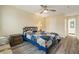 Bright bedroom with ceiling fan, warm wall color, and laminate flooring at 11200 102Nd Ave # 16, Seminole, FL 33778
