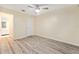 Bedroom featuring a ceiling fan, plank floors, and a convenient ensuite bathroom at 11200 102Nd Ave # 16, Seminole, FL 33778